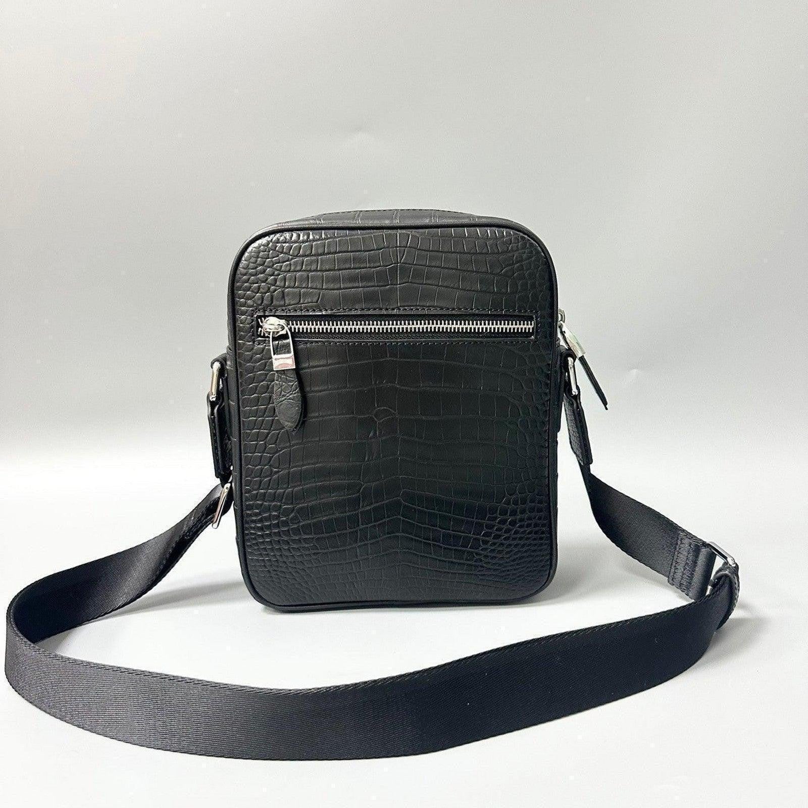 black alligator leather crossbody bag showing front exterior zip pocket