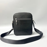 black alligator leather crossbody bag showing front exterior zip pocket