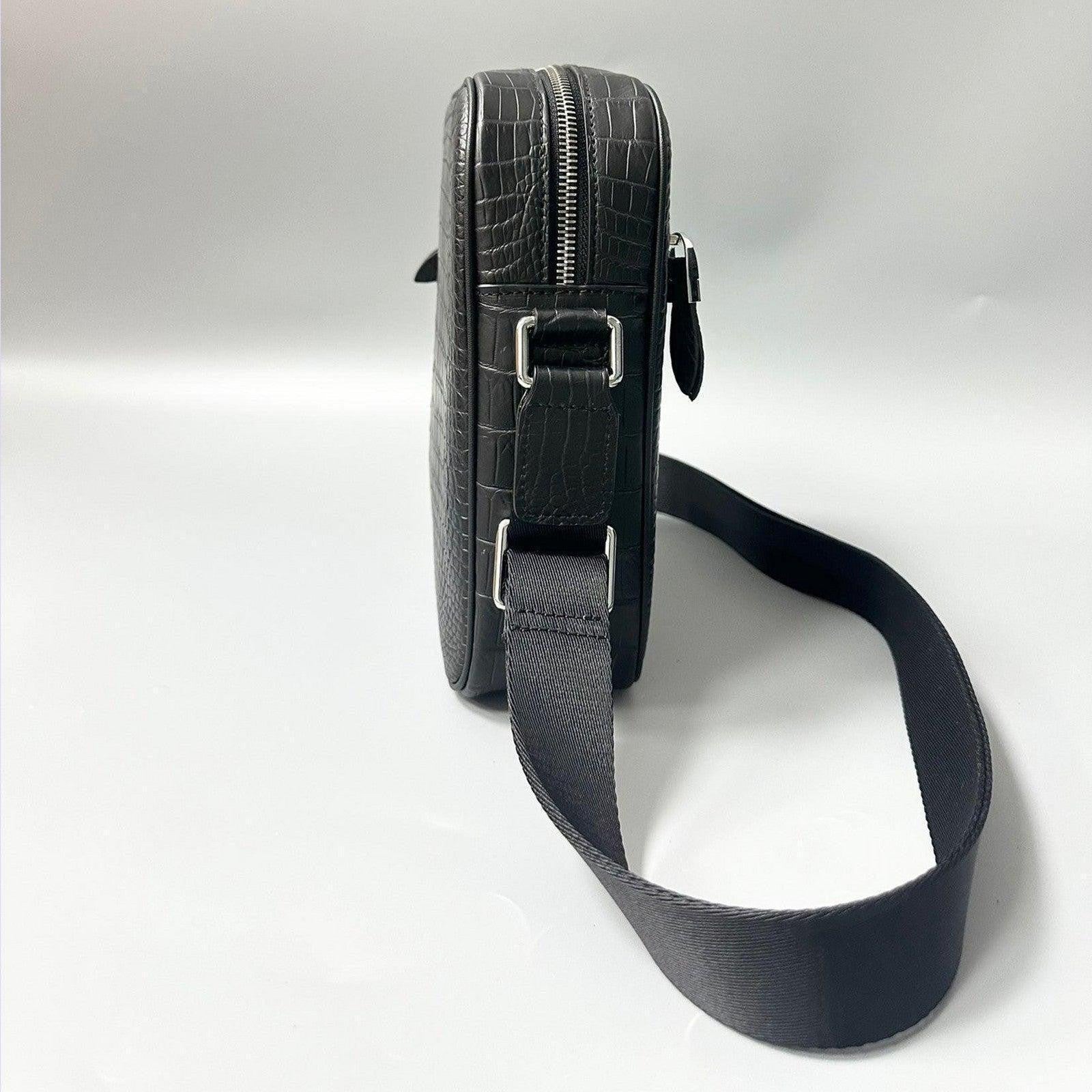 side view of alligator leather crossbody bag showing structured profile and strap attachment