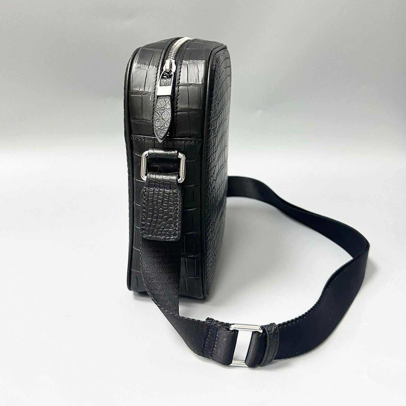 black alligator leather crossbody bag side profile showing structured shape and strap buckle