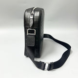 black alligator leather crossbody bag side profile showing structured shape and strap buckle