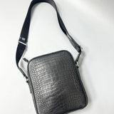 gray alligator leather crossbody bag with adjustable shoulder strap