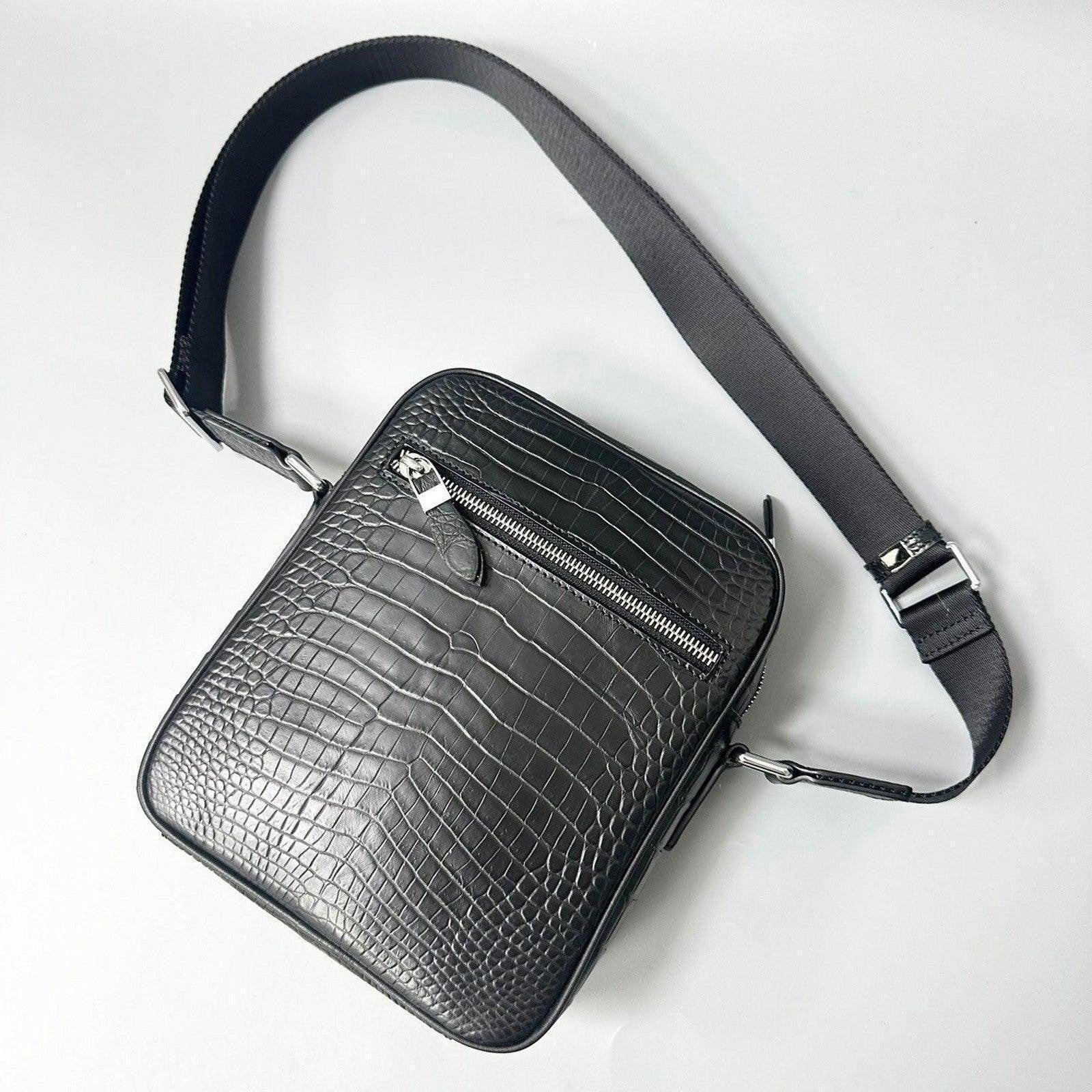 gray alligator leather crossbody bag front view showing exterior zip pocket