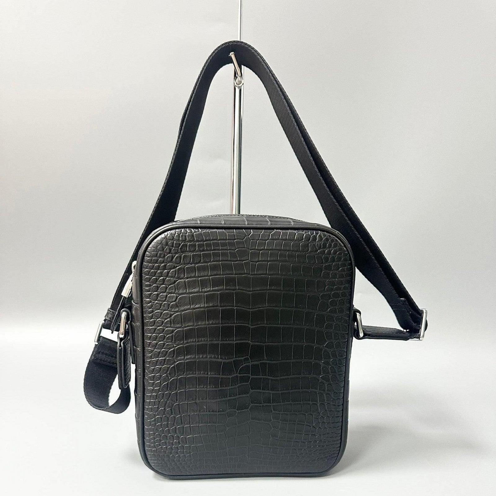 alligator leather crossbody bag hanging view showing adjustable strap and overall shape