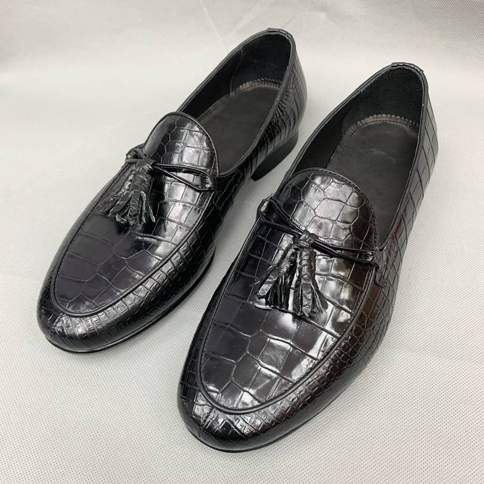 Premium black handmade alligator tassel loafers for men featuring exotic leather texture and timeless slip-on style