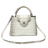 White Alligator skin handbag with a strap on a gray background